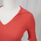 Coral rib knit short sleeve polo on a white background - close up
