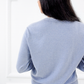 Back view of the Jasmin cotton cardigan in Cielo blue showing its relaxed fit and ribbed hem