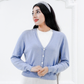 Front view of the Jasmin cotton cardigan in Cielo blue with a V-neckline, long sleeves, and flower buttons