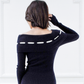 Back view of the Lisette navy merino off-shoulder top showing the ribbed foldover neckline and white ribbon detail