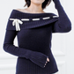 Detail view of the Lisette navy merino off-shoulder top highlighting the waffle knit, ribbed hem, and long cuffs