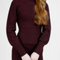 Maroon sweater worn by a person on a white background