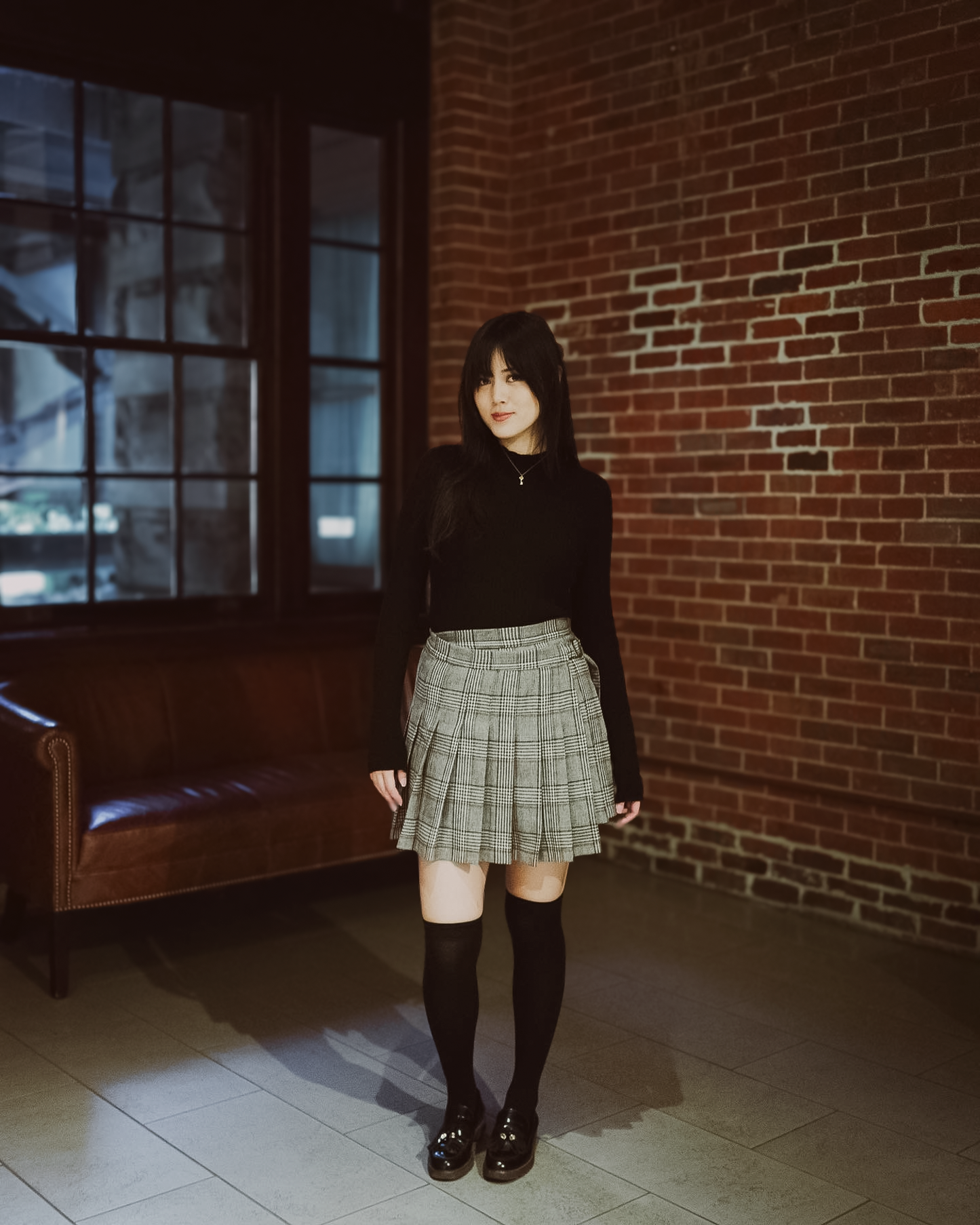 a young woman wearing a black long sleeve Val top and a Sylvie wrap skirt.