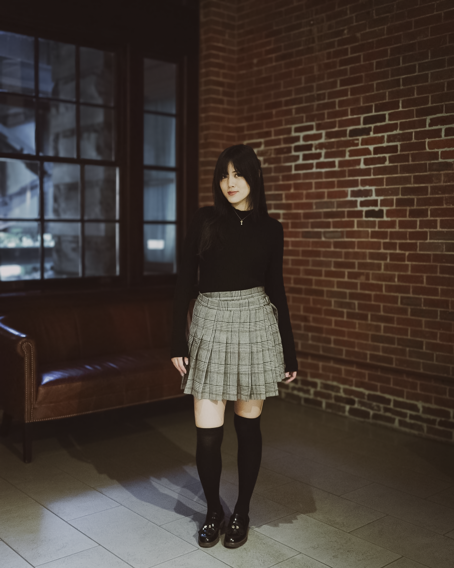 a young woman wearing a black long sleeve Val top and a Sylvie wrap skirt.