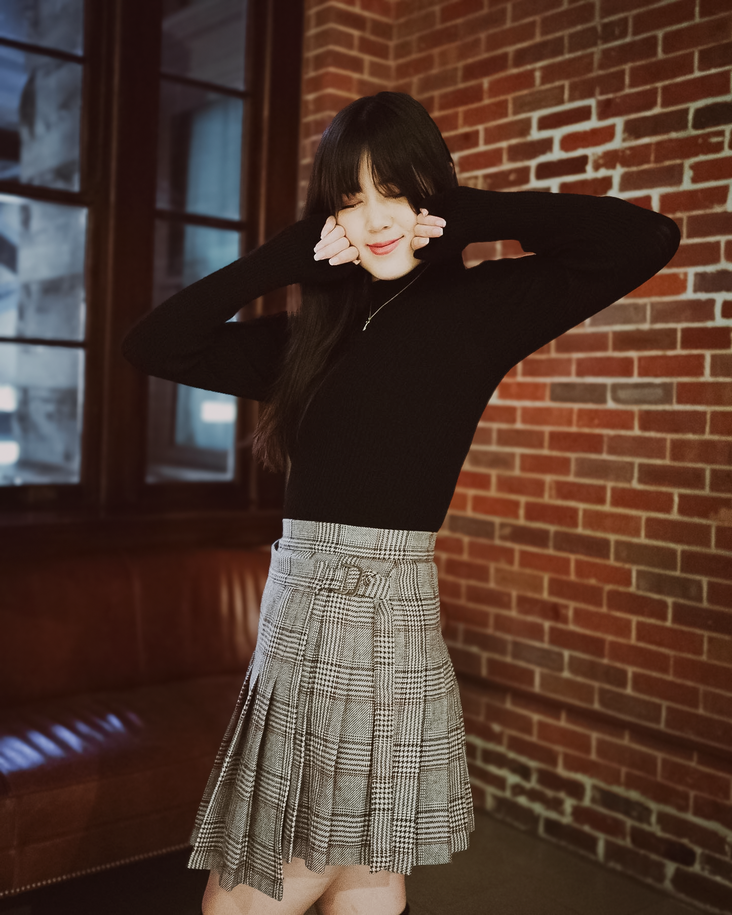 a young woman wearing a black long sleeve Val top and a Sylvie wrap skirt.